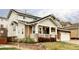 Charming two-story home with a stone facade, front porch, and landscaped front yard at 6103 S Millbrook Ct, Aurora, CO 80016
