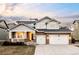 Charming two-story home with a two-car garage, covered porch, and stone accents at 6103 S Millbrook Ct, Aurora, CO 80016