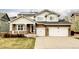 Charming two-story home with a stone facade, solar panels, and an attached two-car garage at 6103 S Millbrook Ct, Aurora, CO 80016