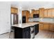 Well-equipped kitchen with granite countertops, wine cooler, stainless steel appliances, and wood cabinets at 6103 S Millbrook Ct, Aurora, CO 80016