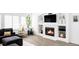 Stylish living room featuring a cozy fireplace and recessed shelving with modern decor accents at 6103 S Millbrook Ct, Aurora, CO 80016