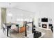 Open concept living area with a dining table, banquette seating, and a cozy fireplace at 6103 S Millbrook Ct, Aurora, CO 80016