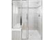 Modern bathroom featuring a tiled shower with glass doors and a built-in bench at 6103 S Millbrook Ct, Aurora, CO 80016