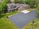 Expansive aerial view of a beautiful home with a large driveway, lush lawn and mature landscaping at 6895 S Norfolk St, Foxfield, CO 80016