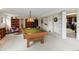 Basement featuring a billiard table with bookshelves, and a passageway leading to a storage room at 6895 S Norfolk St, Foxfield, CO 80016