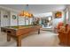 Spacious basement featuring a pool table, living space, and built-in shelving at 6895 S Norfolk St, Foxfield, CO 80016