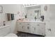 Clean bathroom featuring a large mirror, vanity, and neutral color scheme at 6895 S Norfolk St, Foxfield, CO 80016