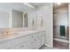 Bright bathroom features dual sinks with vanity, large mirror and tiled walk-in shower at 6895 S Norfolk St, Foxfield, CO 80016