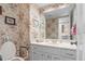Bathroom with floral wallpaper, white vanity, and framed art at 6895 S Norfolk St, Foxfield, CO 80016
