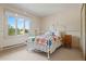 Bedroom with a white iron bed frame and natural light at 6895 S Norfolk St, Foxfield, CO 80016