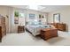Bedroom with a skylight, bright white walls, and wood furniture at 6895 S Norfolk St, Foxfield, CO 80016