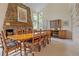 Elegant dining room with large stone fireplace and bright light from many windows at 6895 S Norfolk St, Foxfield, CO 80016