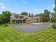 Charming home boasts a grand entrance, three-car garage, and lush landscaping at 6895 S Norfolk St, Foxfield, CO 80016