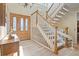 Inviting foyer featuring hardwood floors, a staircase, and a decorative front door at 6895 S Norfolk St, Foxfield, CO 80016