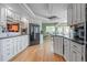 Bright kitchen with white cabinets, wood floors, and modern appliances at 6895 S Norfolk St, Foxfield, CO 80016