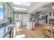 Bright kitchen with hardwood floors, bar seating, and an island at 6895 S Norfolk St, Foxfield, CO 80016