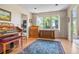 Bright room with hardwood flooring, a large window, and vintage organ at 6895 S Norfolk St, Foxfield, CO 80016