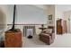 Loft featuring a chair, side table, and mounted TV at 6895 S Norfolk St, Foxfield, CO 80016