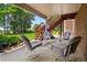 Covered patio featuring outdoor seating and views of the landscaped yard at 6895 S Norfolk St, Foxfield, CO 80016