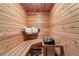 Cozy wooden sauna with bench seating and traditional sauna stones for relaxation at 6895 S Norfolk St, Foxfield, CO 80016