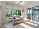 Inviting sunroom with comfortable seating, large windows, and skylights providing ample natural light at 6895 S Norfolk St, Foxfield, CO 80016