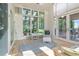 Relaxing sunroom with large windows, tile flooring, and comfortable seating for enjoying the outdoors at 6895 S Norfolk St, Foxfield, CO 80016
