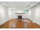 Finished basement space with white walls, a brick fireplace, and unique cork flooring at 810 Adams St, Denver, CO 80206