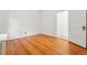 A bright bedroom featuring wooden floors, radiator and a large door at 810 Adams St, Denver, CO 80206