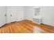 A bright bedroom featuring wooden floors, radiator and a large window at 810 Adams St, Denver, CO 80206