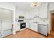 Functional kitchen with white cabinets, countertops, and stainless steel dishwasher at 810 Adams St, Denver, CO 80206