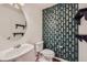 Stylish powder room with a unique accent wall and modern fixtures at 1436 Turnberry Dr, Castle Rock, CO 80104