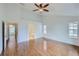 Bright primary bedroom featuring hardwood floors and an ensuite bathroom entrance at 1436 Turnberry Dr, Castle Rock, CO 80104