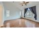 Bedroom featuring hardwood floors, a ceiling fan, and two large windows for ample natural light at 1436 Turnberry Dr, Castle Rock, CO 80104