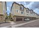 Exterior view of townhomes with stone accents and attached garages at 1436 Turnberry Dr, Castle Rock, CO 80104