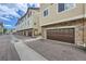 Row of townhomes with stone accents and attached garages offer street view at 1436 Turnberry Dr, Castle Rock, CO 80104