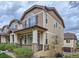 Charming townhome with a inviting front porch and stone accents at 1436 Turnberry Dr, Castle Rock, CO 80104