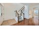 Entryway with tile and wood flooring leading to stairs and an arched doorway at 1436 Turnberry Dr, Castle Rock, CO 80104