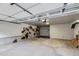 Spacious garage with an open ceiling, storage shelving, and an artful accent wall at 1436 Turnberry Dr, Castle Rock, CO 80104