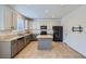 Spacious kitchen features neutral countertops and flooring, stainless appliances, and island at 1436 Turnberry Dr, Castle Rock, CO 80104