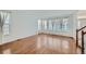 Bright living room with hardwood floors, large windows, and sheer curtains letting in ample natural light at 1436 Turnberry Dr, Castle Rock, CO 80104