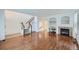 Spacious living room boasting hardwood floors, staircase, fireplace, and built-in desk for flexible living at 1436 Turnberry Dr, Castle Rock, CO 80104
