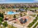 Aerial view of the playground, pool, and community center offering a variety of recreational activities and social spaces at 17035 E 102Nd Pl, Commerce City, CO 80022