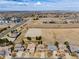 Expansive aerial view showing a neighborhood with modern homes and convenient access to urban amenities at 17035 E 102Nd Pl, Commerce City, CO 80022