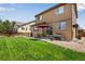 Expansive backyard with a well-kept lawn, patio with a grill, and mature landscaping for outdoor enjoyment at 17035 E 102Nd Pl, Commerce City, CO 80022