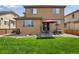 Spacious backyard with a patio, perfect for outdoor dining and entertaining under a red umbrella at 17035 E 102Nd Pl, Commerce City, CO 80022
