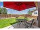 Relaxing backyard patio featuring a metal table with chairs, perfect for enjoying outdoor living at 17035 E 102Nd Pl, Commerce City, CO 80022