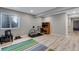 Finished basement with light floors, gray walls, desk, workout bike and a window at 17035 E 102Nd Pl, Commerce City, CO 80022