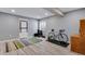 Finished basement with grey walls, light floors, an exercise bike, and workout equipment at 17035 E 102Nd Pl, Commerce City, CO 80022