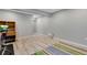 Finished basement featuring light floors, gray walls, and a partially visible workout bike at 17035 E 102Nd Pl, Commerce City, CO 80022