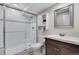 Modern bathroom with a glass shower, vanity, white tile, and stylish fixtures at 17035 E 102Nd Pl, Commerce City, CO 80022